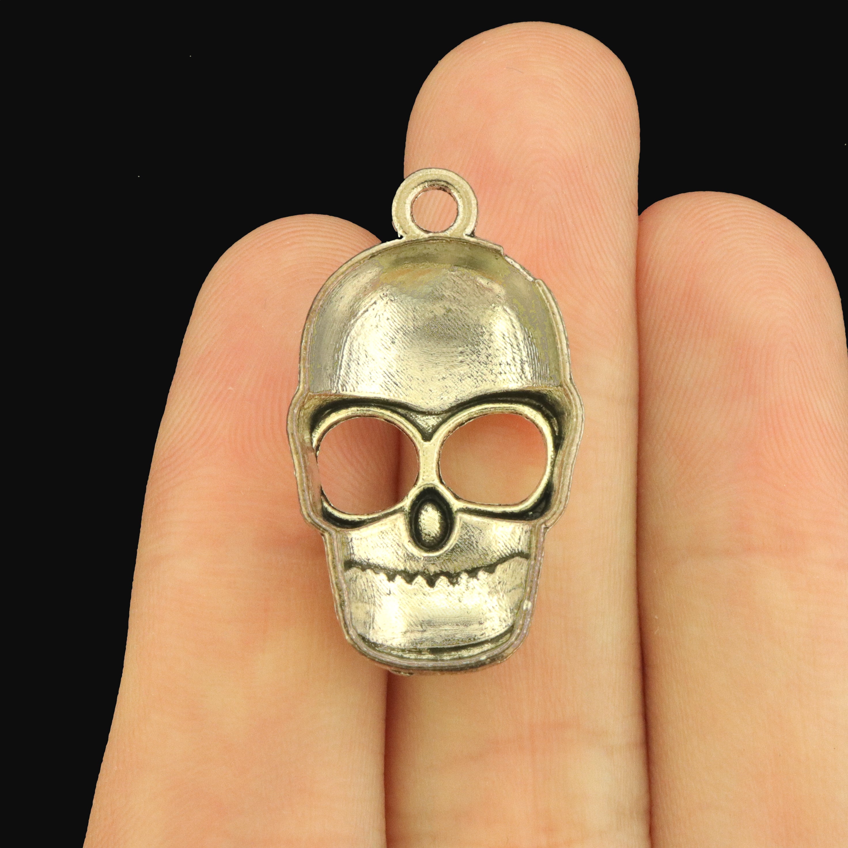 10 Smiling Skull Antique Silver Tone Charms - SC588