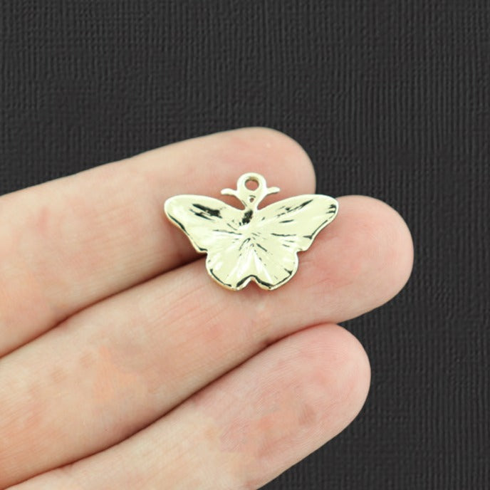 4 breloques papillon en émail doré - E743