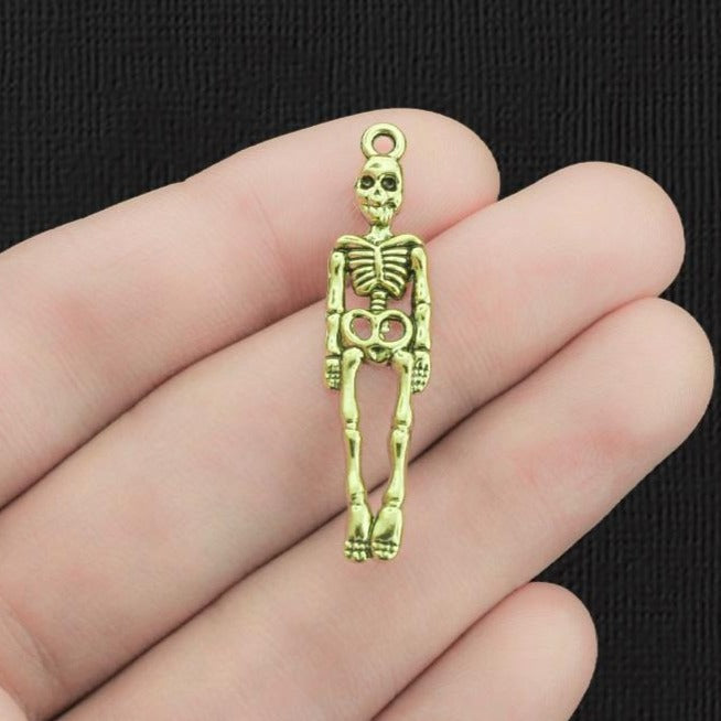 4 Charms Squelette Doré - GC390