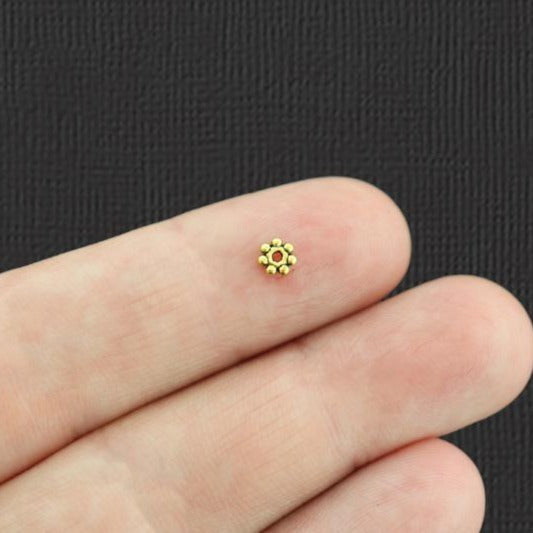 Perles intercalaires marguerite 4 mm - ton or antique - 100 perles - GC077