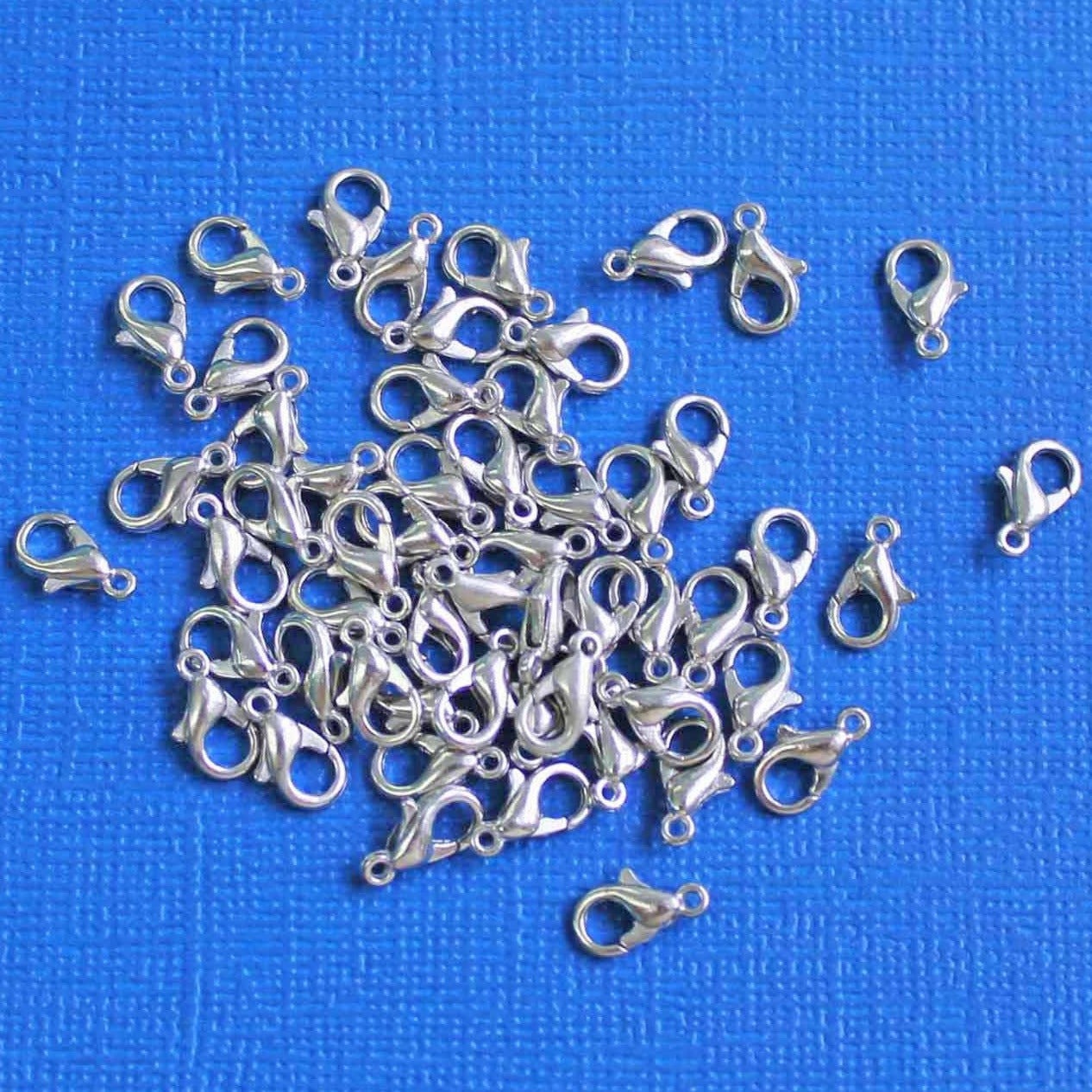 Fermoirs mousqueton argentés 10 mm x 6 mm - 50 fermoirs - FD467