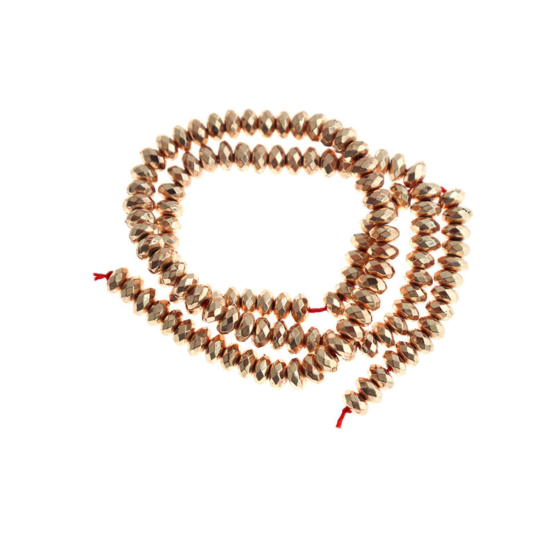 Rondelle à facettes en hématite synthétique 5,5 mm x 3 mm - Or rose électrolytique - 1 brin 131 perles - BD159