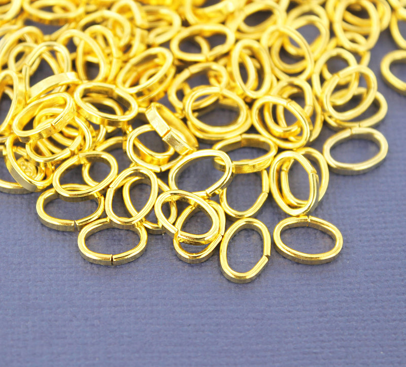 Anneaux ovales dorés 10 mm x 7 mm, 2 mm x 1 mm - Calibre ouvert 12 x 18 - 100 anneaux - J079