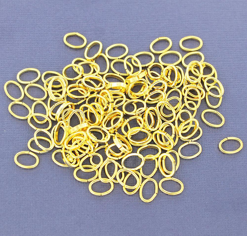 Anneaux ovales dorés 10 mm x 7 mm, 2 mm x 1 mm - Calibre ouvert 12 x 18 - 100 anneaux - J079