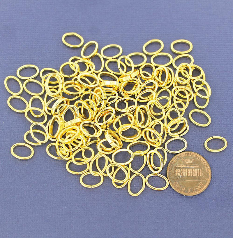Anneaux ovales dorés 10 mm x 7 mm, 2 mm x 1 mm - Calibre ouvert 12 x 18 - 100 anneaux - J079