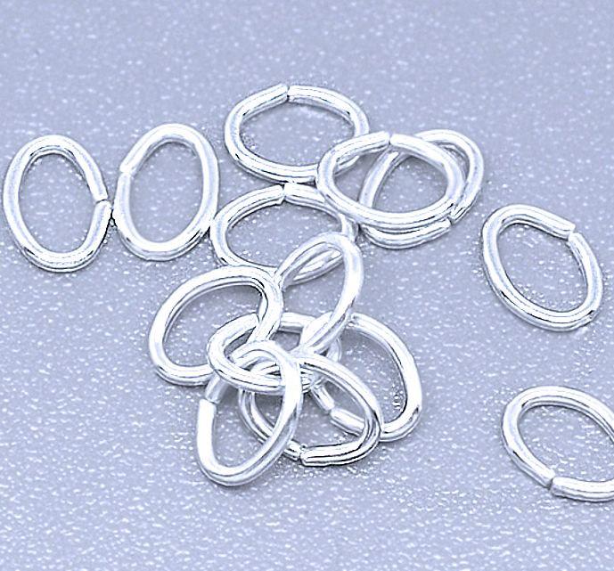 Anneaux ovales argentés 5,5 mm x 4 mm x 0,7 mm - Calibre 21 ouvert - 200 anneaux - J056