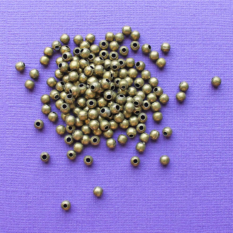 Perles d'espacement rondes 2 mm x 7 mm - Ton bronze - 500 perles - FD233