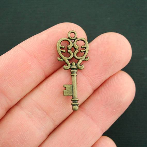 8 Key Antique Bronze Tone Charms 2 Sided - BC481
