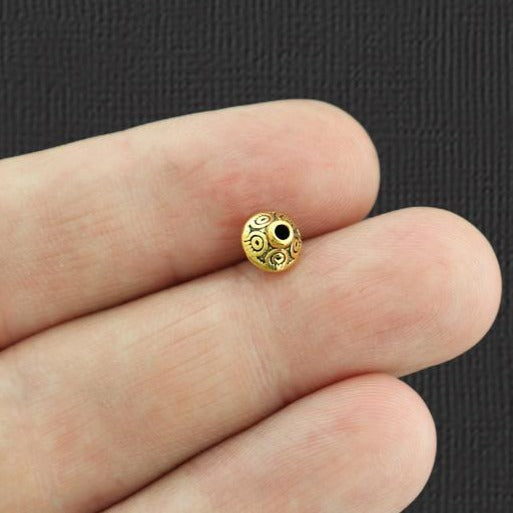 Perles intercalaires toupies 6,4 mm x 7,5 mm - ton or antique - 25 perles - GC850