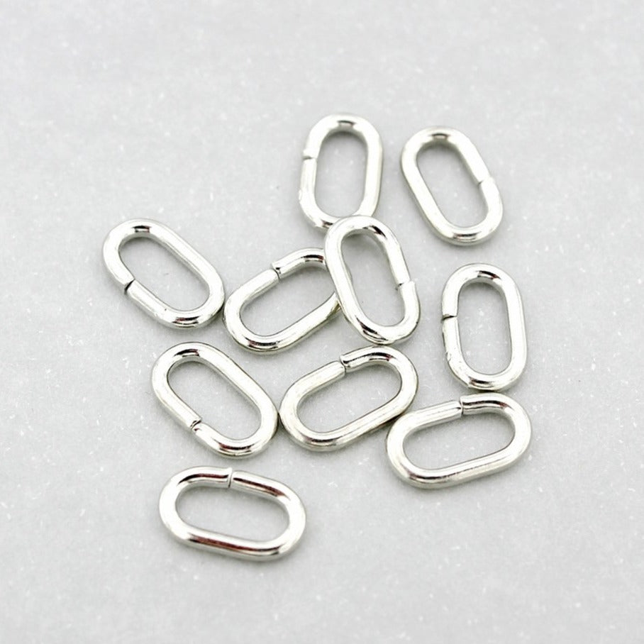 Anneaux ovales argentés 11 mm x 6 mm x 1,5 mm - Calibre 15 ouvert - 50 anneaux - J189