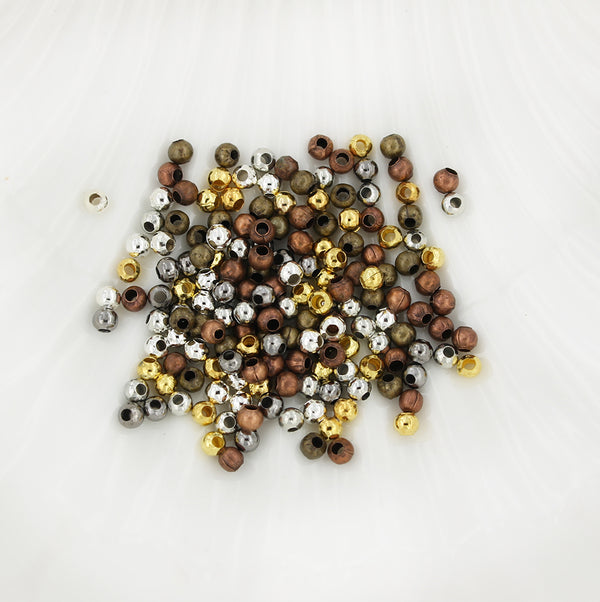 Perles intercalaires rondes 3 mm x 3,2 mm - Assortiment de tons argent, bronze, or et cuivre - 500 perles - FD372